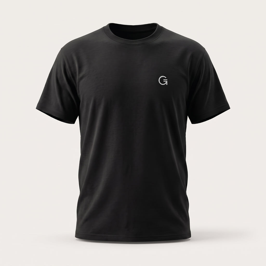 A ghost mannequin showing a black short-sleeve t-shirt with a white “Clobber & Gear” logo embroidered on the left chest, set against a gradated grey background.