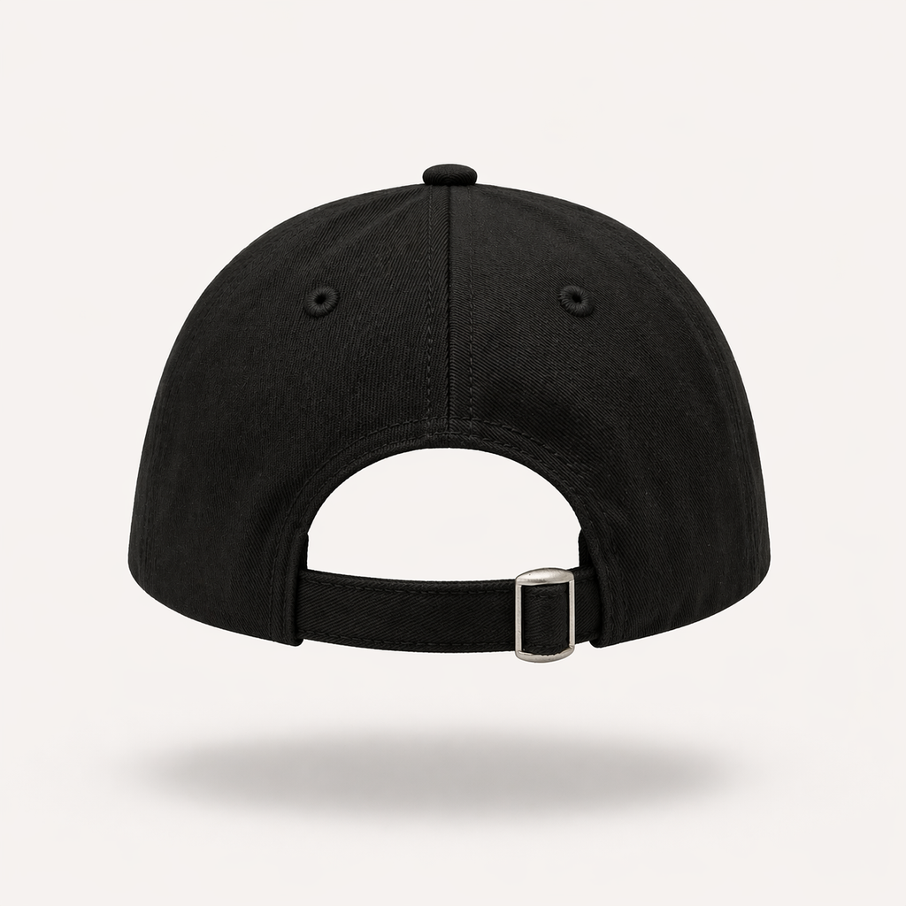 Rear view of a black dad cap featuring an adjustable fabric strap with a silver metal tri-glide buckle, embroidered eyelets, and stitched paneling set against a plain light background.
